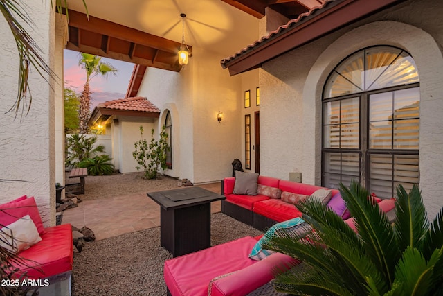 patio terrace at dusk featuring an outdoor hangout area