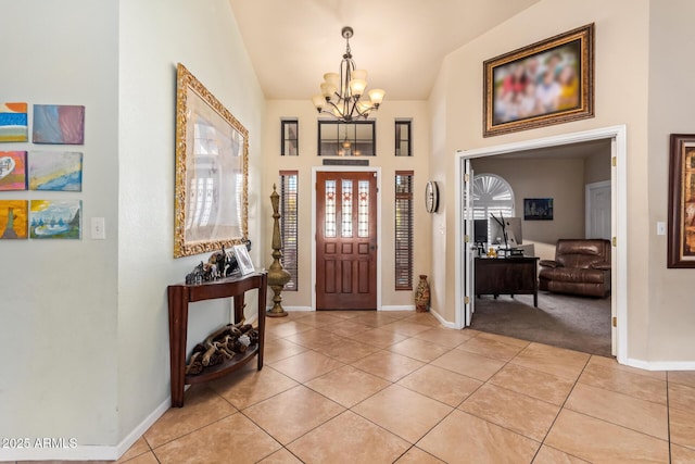 foyer entrance with light tile patterned floors and an inviting chandelier