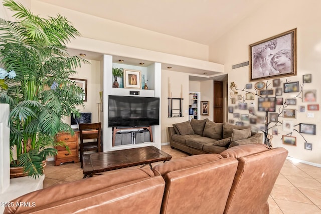 living room featuring light tile patterned floors and high vaulted ceiling