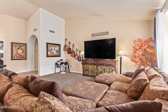 living room with vaulted ceiling and light colored carpet