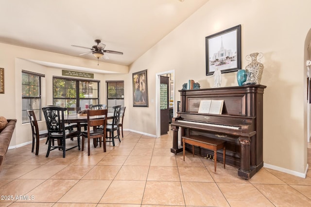 dining area with ceiling fan, light tile patterned floors, and lofted ceiling