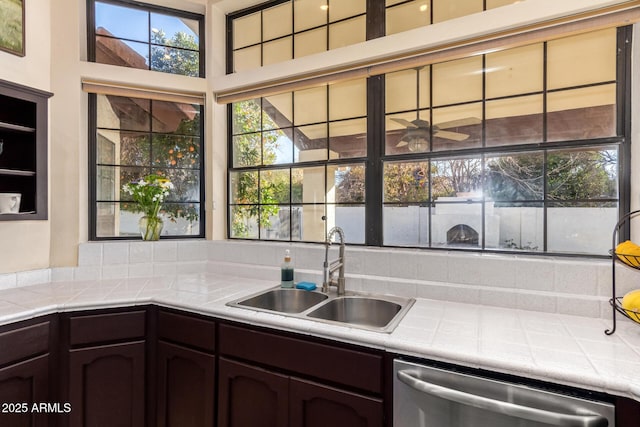 kitchen featuring sink, dark brown cabinetry, dishwasher, and tile countertops