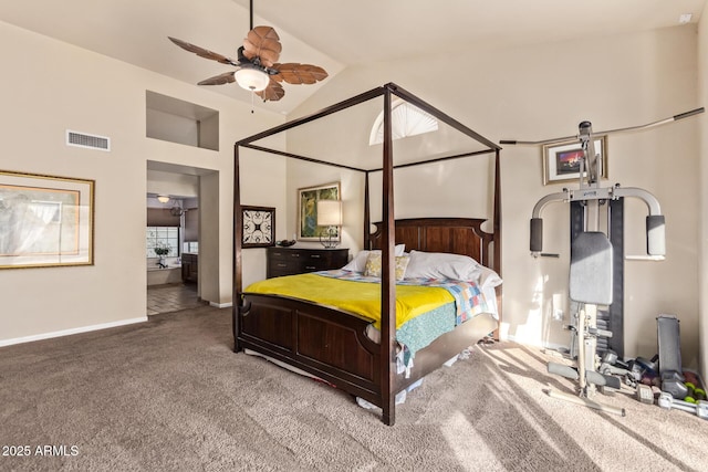 carpeted bedroom featuring ceiling fan, ensuite bathroom, and lofted ceiling