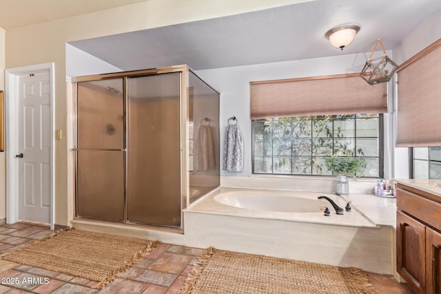 bathroom featuring independent shower and bath, a wealth of natural light, and vanity