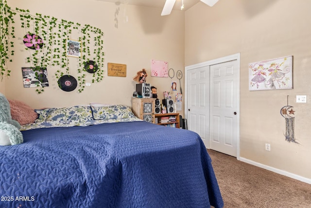 carpeted bedroom featuring ceiling fan and a closet