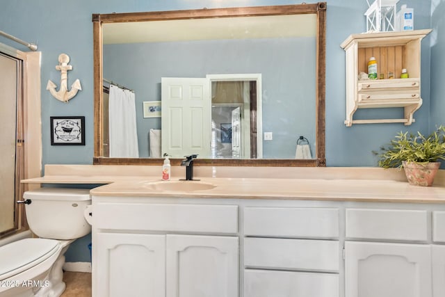 bathroom featuring toilet and vanity