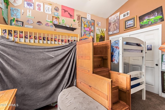 bedroom with a closet, lofted ceiling, and carpet floors