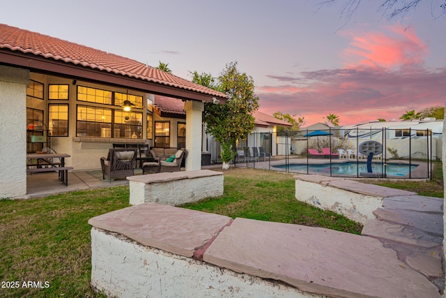 exterior space featuring an outdoor living space, a lawn, and a patio