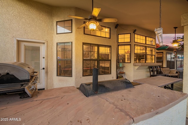 exterior space with ceiling fan