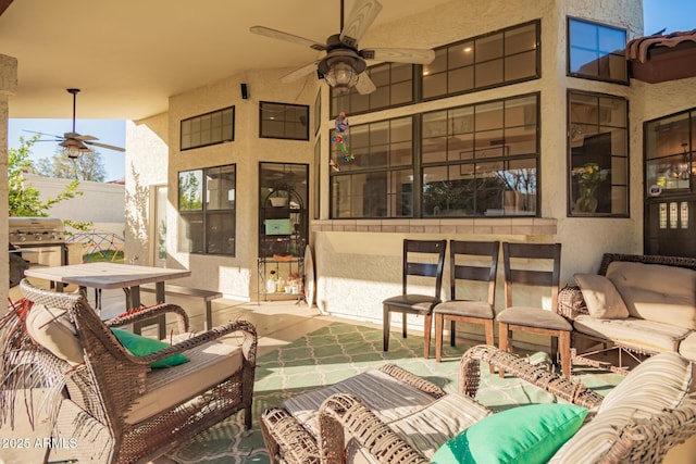 view of patio / terrace with ceiling fan, a grill, and an outdoor living space