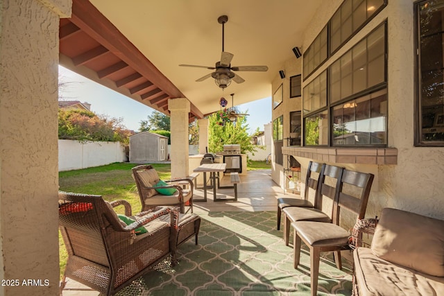 view of patio with ceiling fan, a storage shed, an outdoor living space, and area for grilling