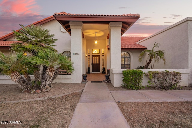 view of exterior entry at dusk