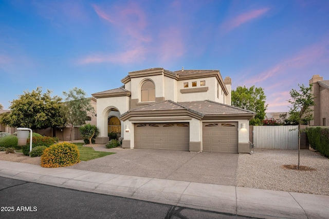 6435 E Monte Cristo Ave, Scottsdale, AZ 85254 - mediterranean / spanish-style house with stucco siding, concrete driveway, a garage, and a tile roof
