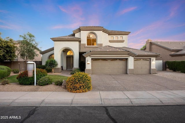 6435 E Monte Cristo Ave, Scottsdale, AZ 85254 - mediterranean / spanish home with a garage, stucco siding, concrete driveway, and a tiled roof