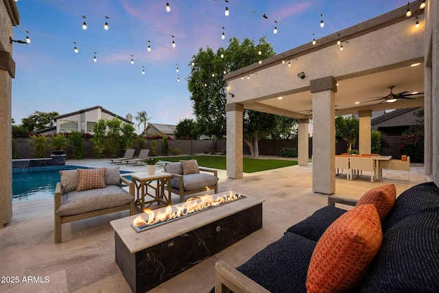 6435 E Monte Cristo Ave, Scottsdale, AZ 85254 - fenced backyard featuring a patio, ceiling fan, an outdoor living space with a fire pit, and outdoor dining space