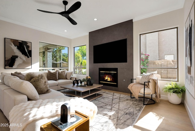 6435 E Monte Cristo Ave, Scottsdale, AZ 85254 - living area with ceiling fan, crown molding, a large fireplace, recessed lighting, and wood finished floors
