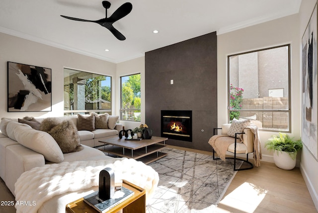 6435 E Monte Cristo Ave, Scottsdale, AZ 85254 - living area featuring ornamental molding, a ceiling fan, a fireplace, recessed lighting, and light wood finished floors