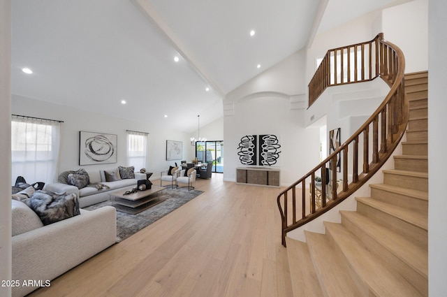 6435 E Monte Cristo Ave, Scottsdale, AZ 85254 - living area featuring light wood-style floors, high vaulted ceiling, stairs, recessed lighting, and a chandelier