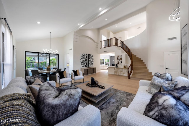 6435 E Monte Cristo Ave, Scottsdale, AZ 85254 - living area with a chandelier, wood finished floors, stairway, recessed lighting, and high vaulted ceiling