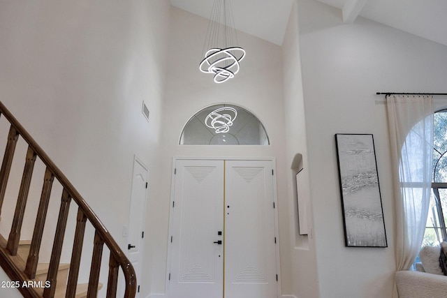 6435 E Monte Cristo Ave, Scottsdale, AZ 85254 - entrance foyer featuring high vaulted ceiling, a chandelier, stairs, and healthy amount of natural light
