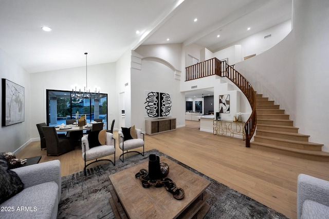 6435 E Monte Cristo Ave, Scottsdale, AZ 85254 - living area with stairs, light wood-style flooring, a chandelier, high vaulted ceiling, and recessed lighting