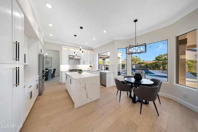 6435 E Monte Cristo Ave, Scottsdale, AZ 85254 - kitchen with stainless steel appliances, a kitchen island, under cabinet range hood, recessed lighting, and backsplash