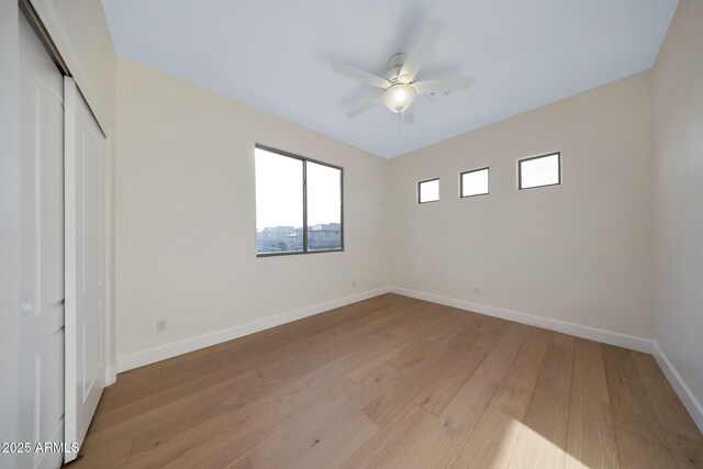 6435 E Monte Cristo Ave, Scottsdale, AZ 85254 - unfurnished bedroom featuring a closet, light wood-style flooring, and a ceiling fan