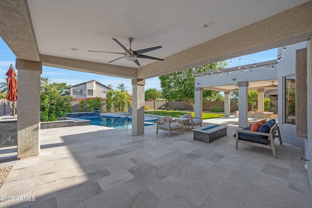 6435 E Monte Cristo Ave, Scottsdale, AZ 85254 - fenced backyard featuring a ceiling fan, a patio area, and an outdoor living space with a fire pit