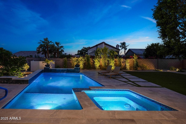 6435 E Monte Cristo Ave, Scottsdale, AZ 85254 - pool at dusk with an in-ground hot tub, a patio area, and a fenced backyard