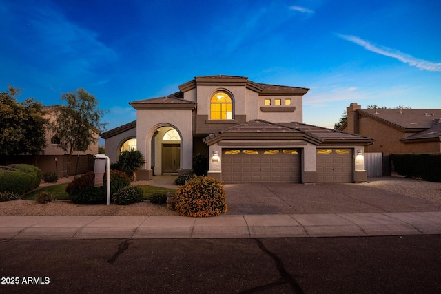6435 E Monte Cristo Ave, Scottsdale, AZ 85254 - mediterranean / spanish house featuring a garage, concrete driveway, stucco siding, and a tiled roof
