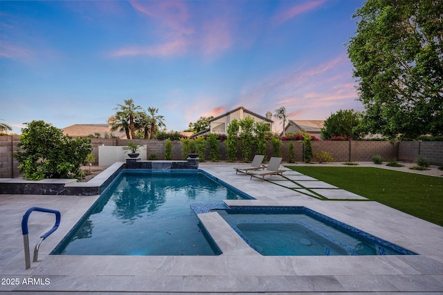 6435 E Monte Cristo Ave, Scottsdale, AZ 85254 - pool at dusk with an in-ground hot tub, a patio, and a fenced backyard