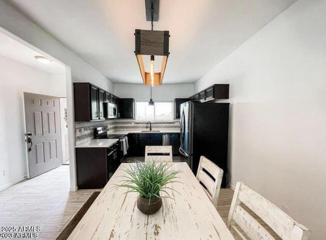 kitchen with stainless steel appliances, sink, and backsplash