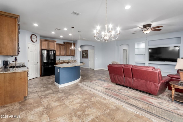 3937 N Smithsonian Dr, Florence, AZ 85132 - living area with arched walkways, ceiling fan with notable chandelier, recessed lighting, baseboards, and visible vents