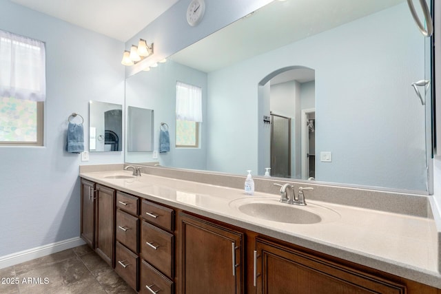 3937 N Smithsonian Dr, Florence, AZ 85132 - bathroom featuring double vanity, baseboards, and a sink
