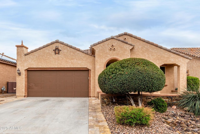 3937 N Smithsonian Dr, Florence, AZ 85132 - mediterranean / spanish home featuring a tiled roof, a garage, cooling unit, concrete driveway, and stucco siding