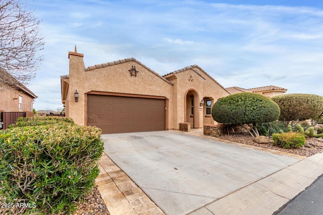 3937 N Smithsonian Dr, Florence, AZ 85132 - mediterranean / spanish home featuring a garage, stucco siding, a tiled roof, and concrete driveway
