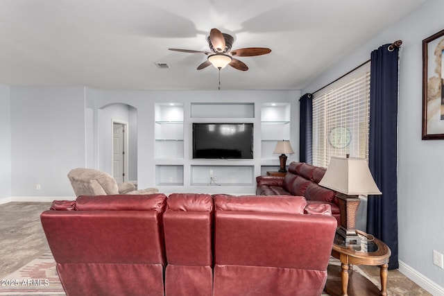 3937 N Smithsonian Dr, Florence, AZ 85132 - living room with visible vents, a ceiling fan, baseboards, built in shelves, and arched walkways
