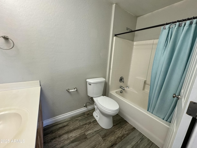 bathroom featuring shower / tub combo with curtain, toilet, vanity, wood finished floors, and baseboards