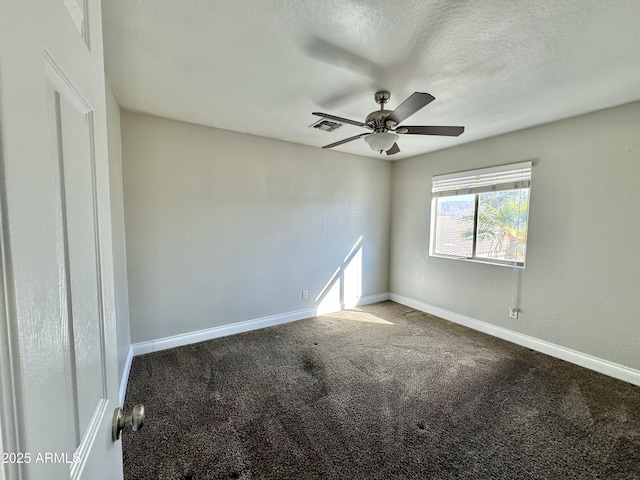 spare room featuring carpet, visible vents, ceiling fan, a textured ceiling, and baseboards