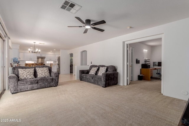 6276 N 75th Ln, Glendale, AZ 85303 - living room featuring light carpet, a ceiling fan, and a chandelier