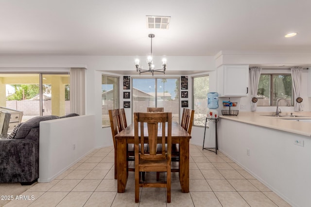 6276 N 75th Ln, Glendale, AZ 85303 - dining room featuring a chandelier, light tile patterned floors, baseboards, and recessed lighting