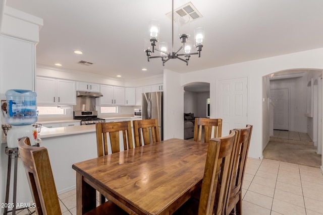 6276 N 75th Ln, Glendale, AZ 85303 - dining room with arched walkways, light tile patterned floors, a chandelier, and recessed lighting