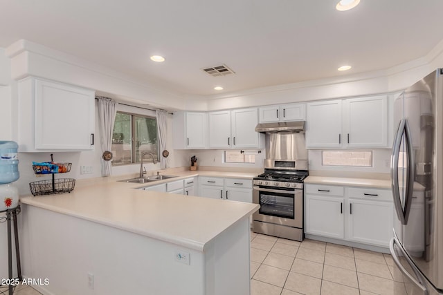 6276 N 75th Ln, Glendale, AZ 85303 - kitchen featuring stainless steel appliances, a sink, under cabinet range hood, white cabinetry, and recessed lighting