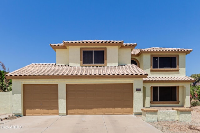 6276 N 75th Ln, Glendale, AZ 85303 - mediterranean / spanish-style home with stucco siding, concrete driveway, and a tiled roof