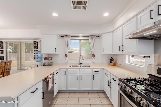 6276 N 75th Ln, Glendale, AZ 85303 - kitchen featuring stainless steel appliances, a sink, light tile patterned floors, white cabinets, and recessed lighting