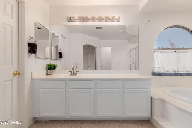 6276 N 75th Ln, Glendale, AZ 85303 - bathroom featuring vanity, a garden tub, and tile patterned floors