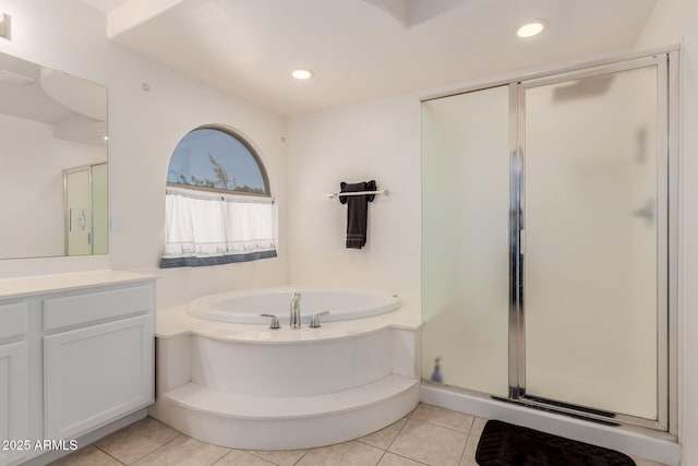 6276 N 75th Ln, Glendale, AZ 85303 - bathroom featuring vanity, a bath, a shower stall, tile patterned flooring, and recessed lighting