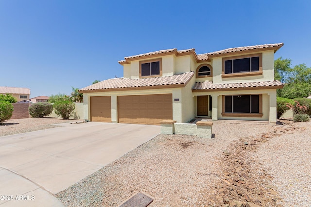 6276 N 75th Ln, Glendale, AZ 85303 - mediterranean / spanish-style house featuring stucco siding, concrete driveway, a tiled roof, and a garage