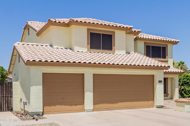 6276 N 75th Ln, Glendale, AZ 85303 - mediterranean / spanish home featuring a tiled roof, driveway, stucco siding, and an attached garage