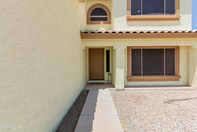 6276 N 75th Ln, Glendale, AZ 85303 - doorway to property featuring stucco siding and a tile roof